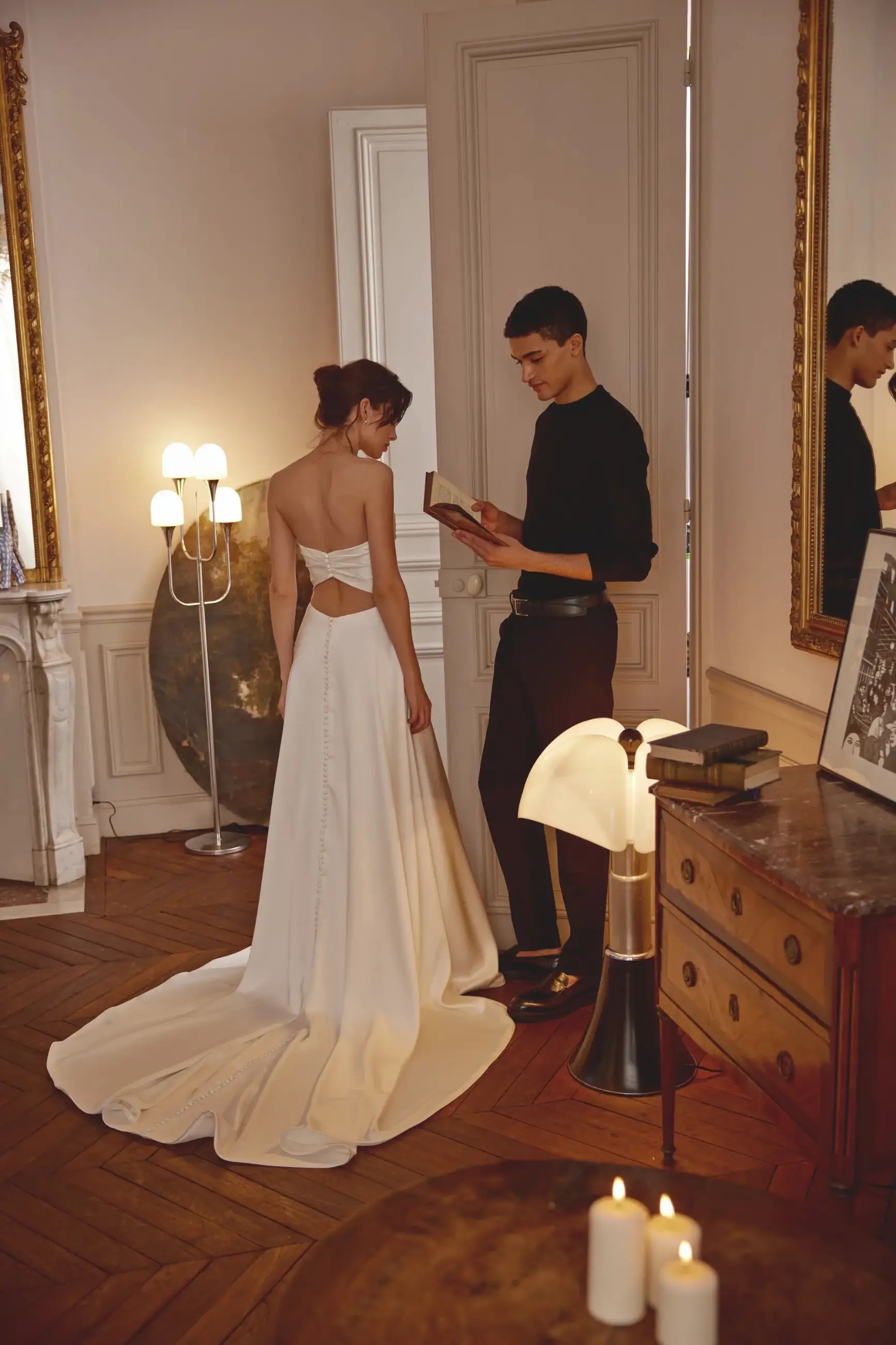 Model is wearing a charmeuse a-line bridal gown with a ruched sweetheart bodice