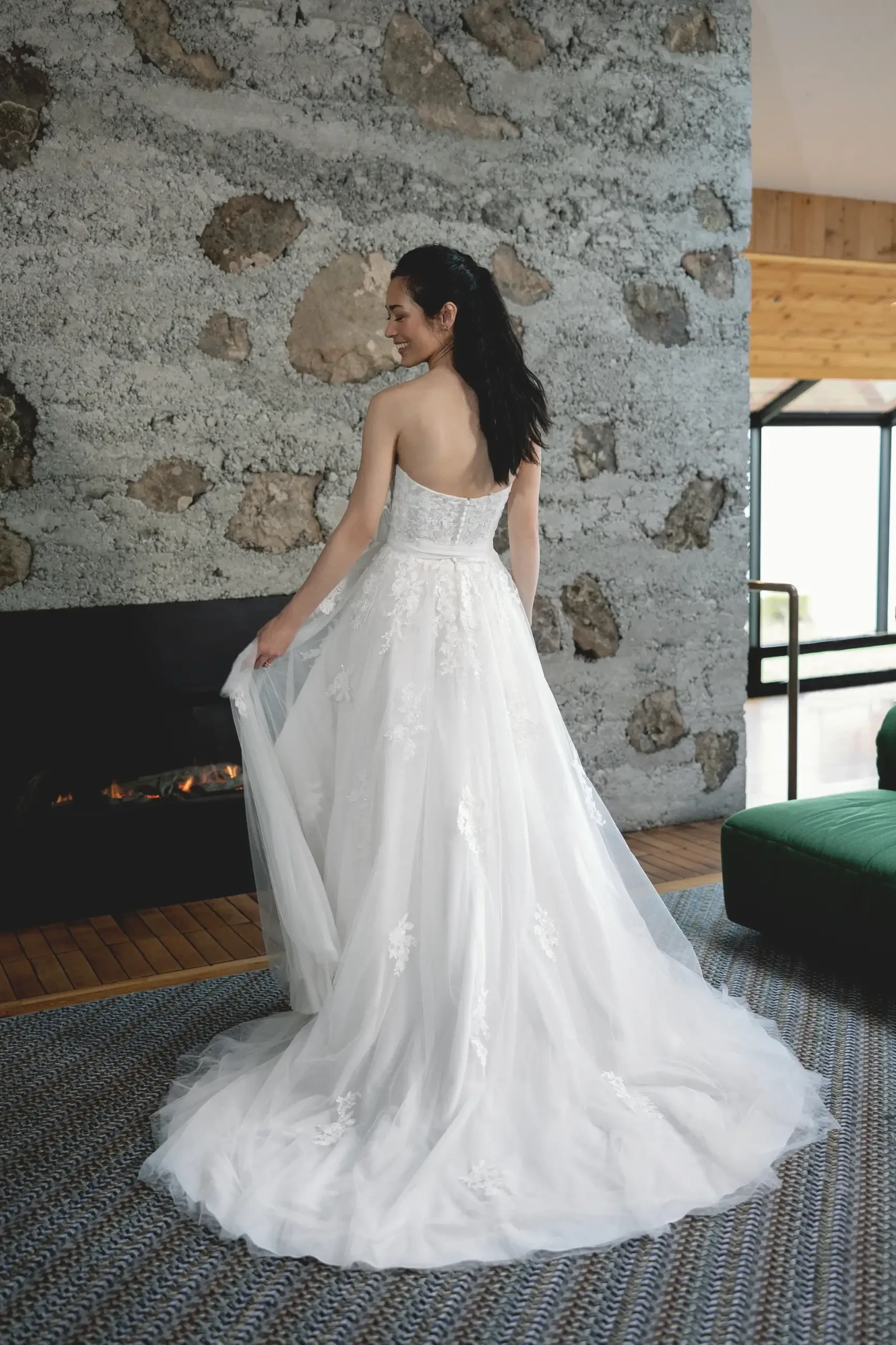 model is wearing a strapless a-line tulle wedding gown