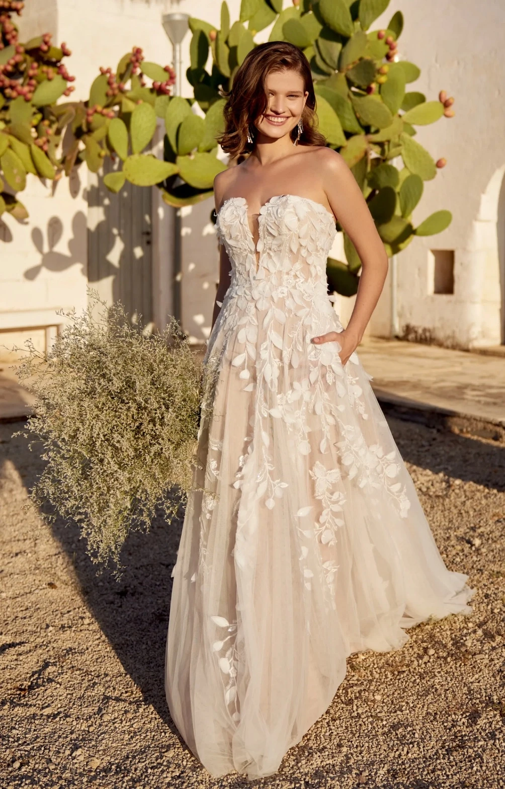 Model wearing a white Lillian West gown